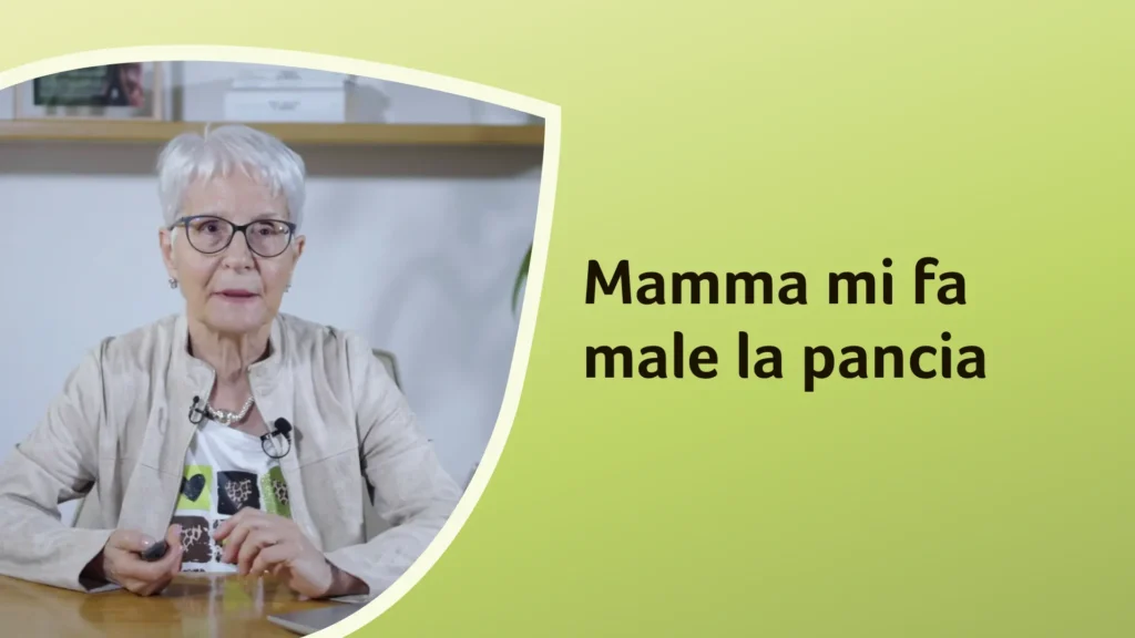 La dottoressa Murgia è seduta e parla in modo rassicurante, indossando un completo chiaro. Sullo sfondo è riportato il titolo dell'episodio: "Mamma mi fa male la pancia"